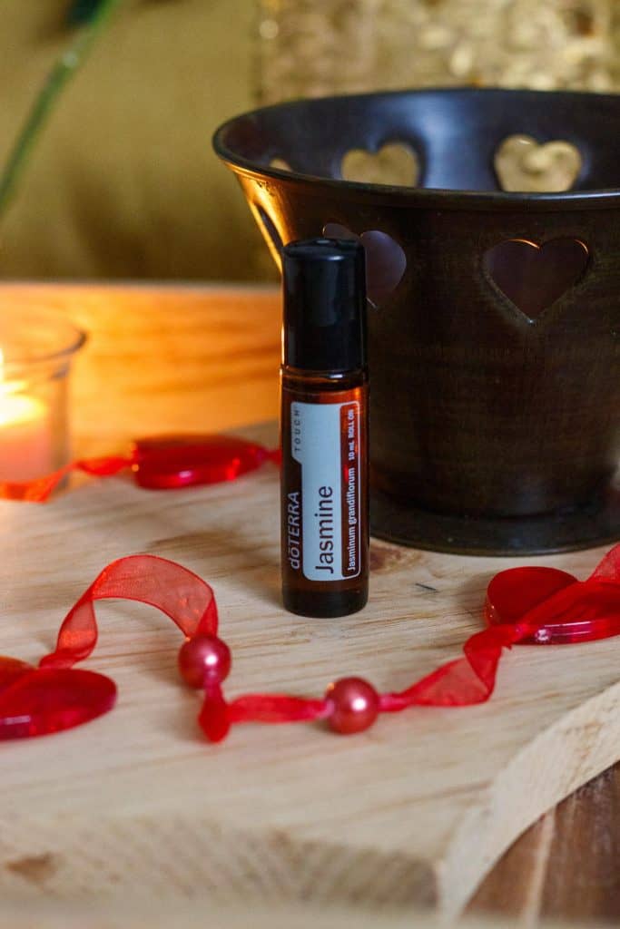 jasmine essential oil next to a candle